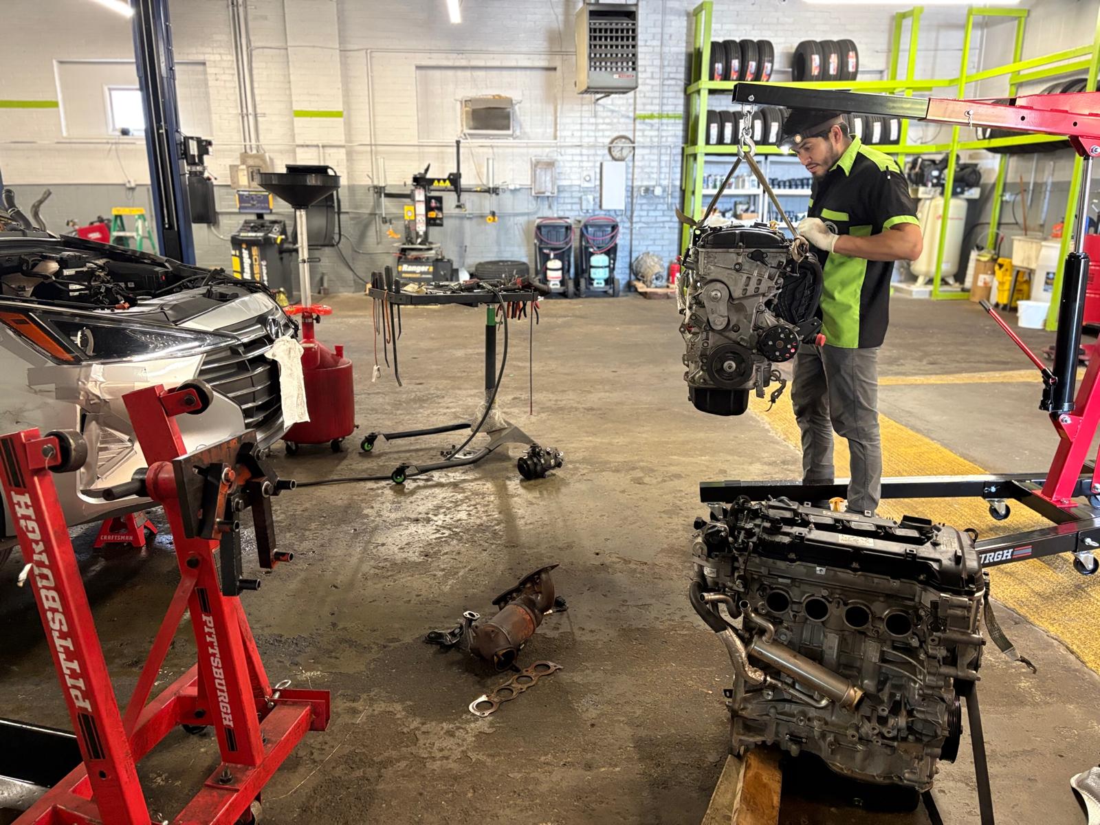 EMA Tire & Auto technicians diagnosing an engine inside the workshop