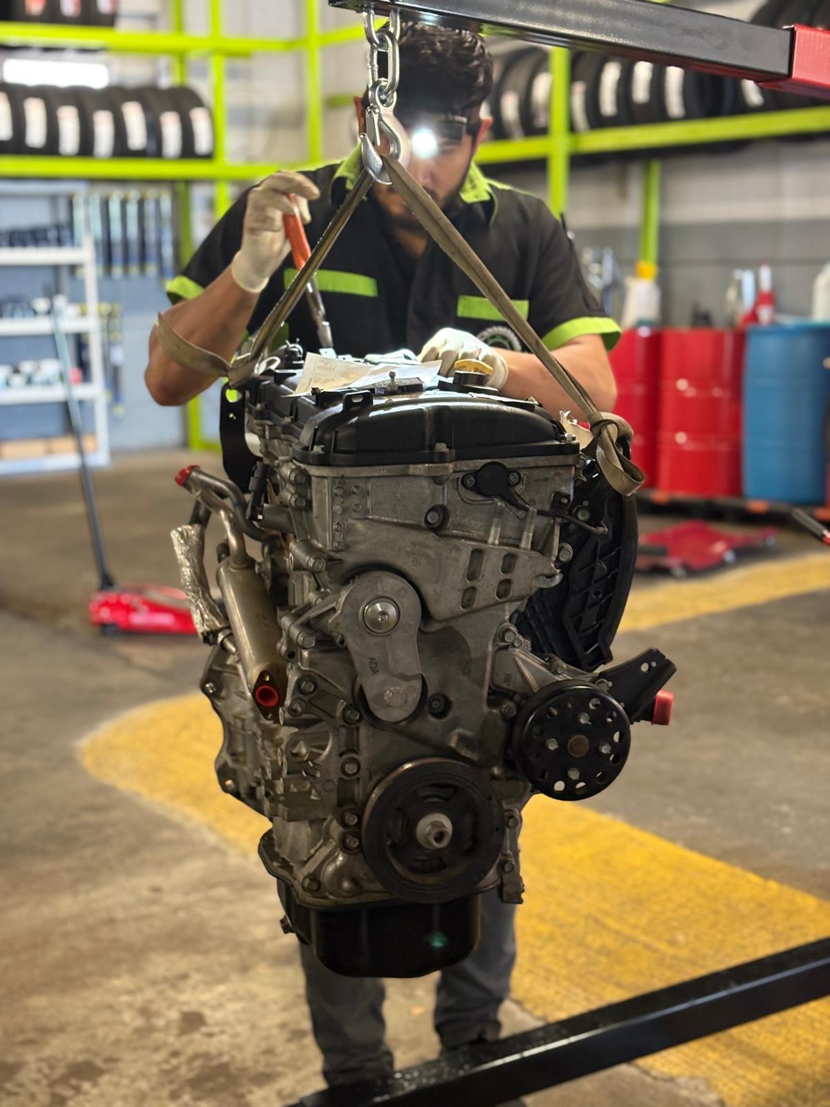 Engine removed from the vehicle for a detailed inspection at EMA Tire & Auto