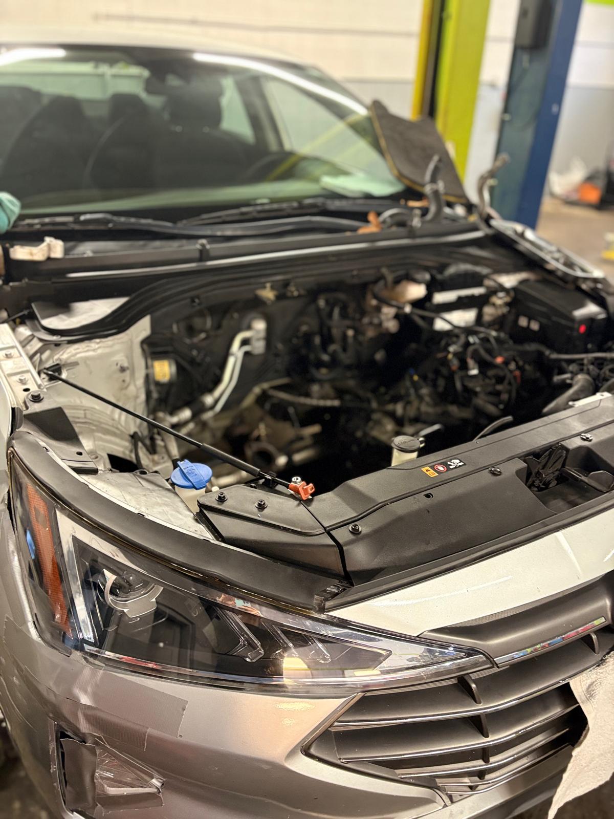 Technician preparing an engine block on a stand at EMA Tire & Auto