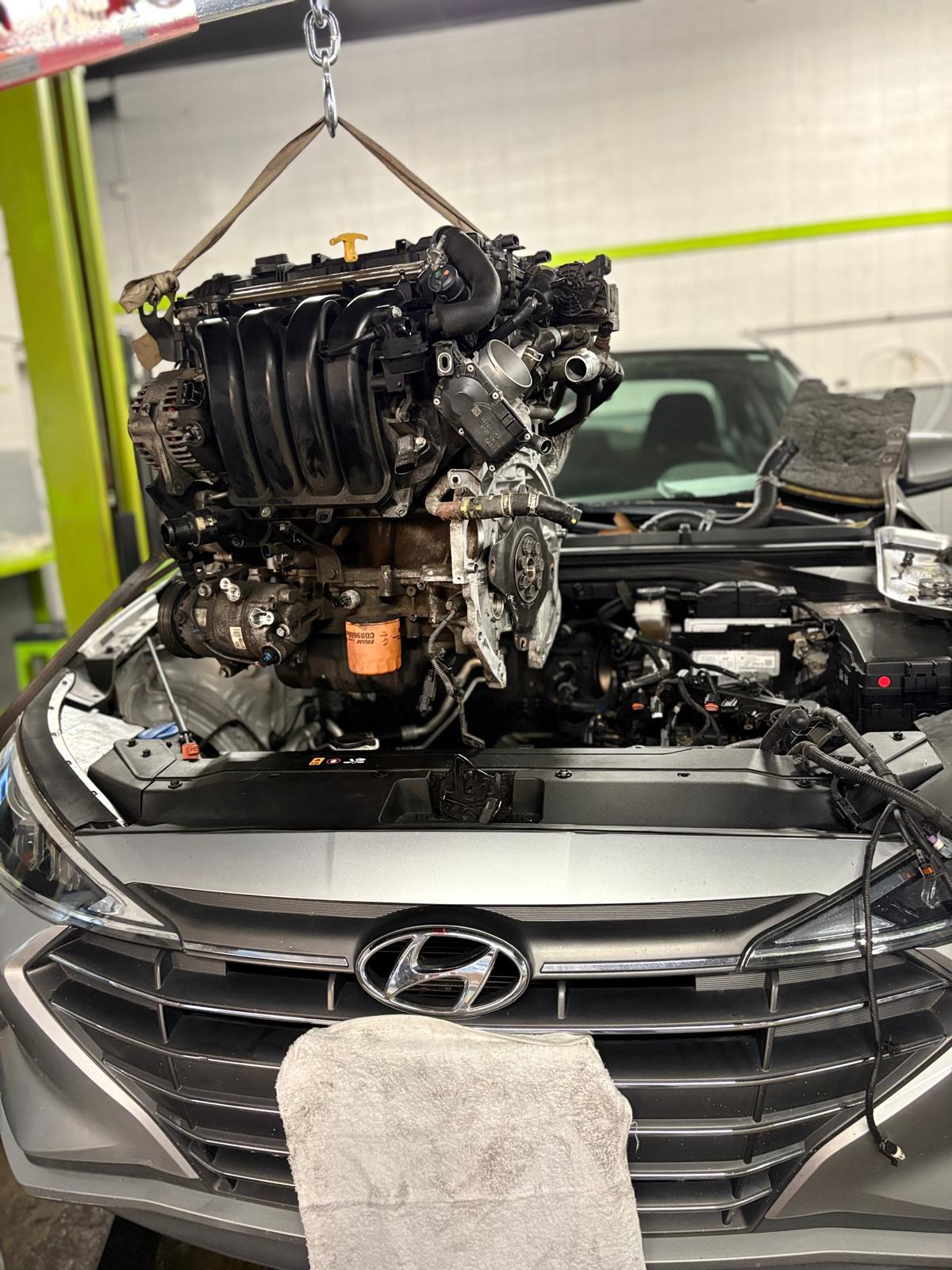 Technician performing final testing on a repaired engine